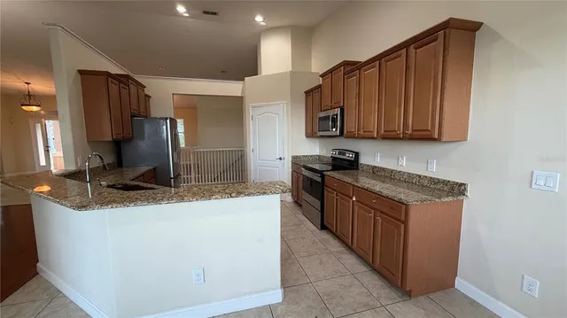 a kitchen with stainless steel appliances granite countertop a refrigerator sink and cabinets