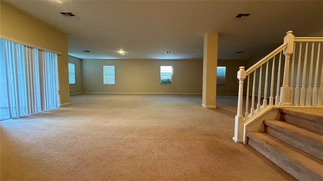 an empty room with projector and windows