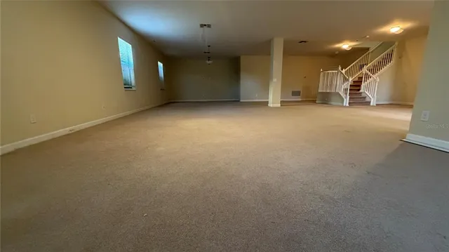 a view of a big room with a ceiling fan