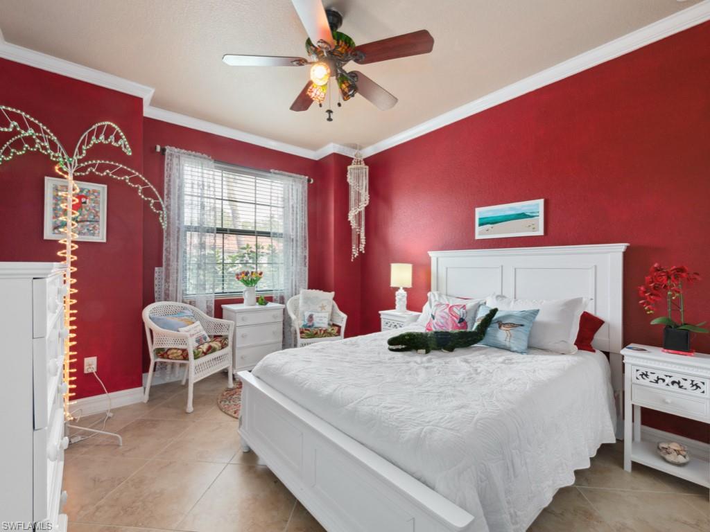 9522 Piacere Way Naples, FL 34113 - Photo 16 of 48 Bedroom with crown molding, a ceiling fan, baseboards, and light tile patterned floors