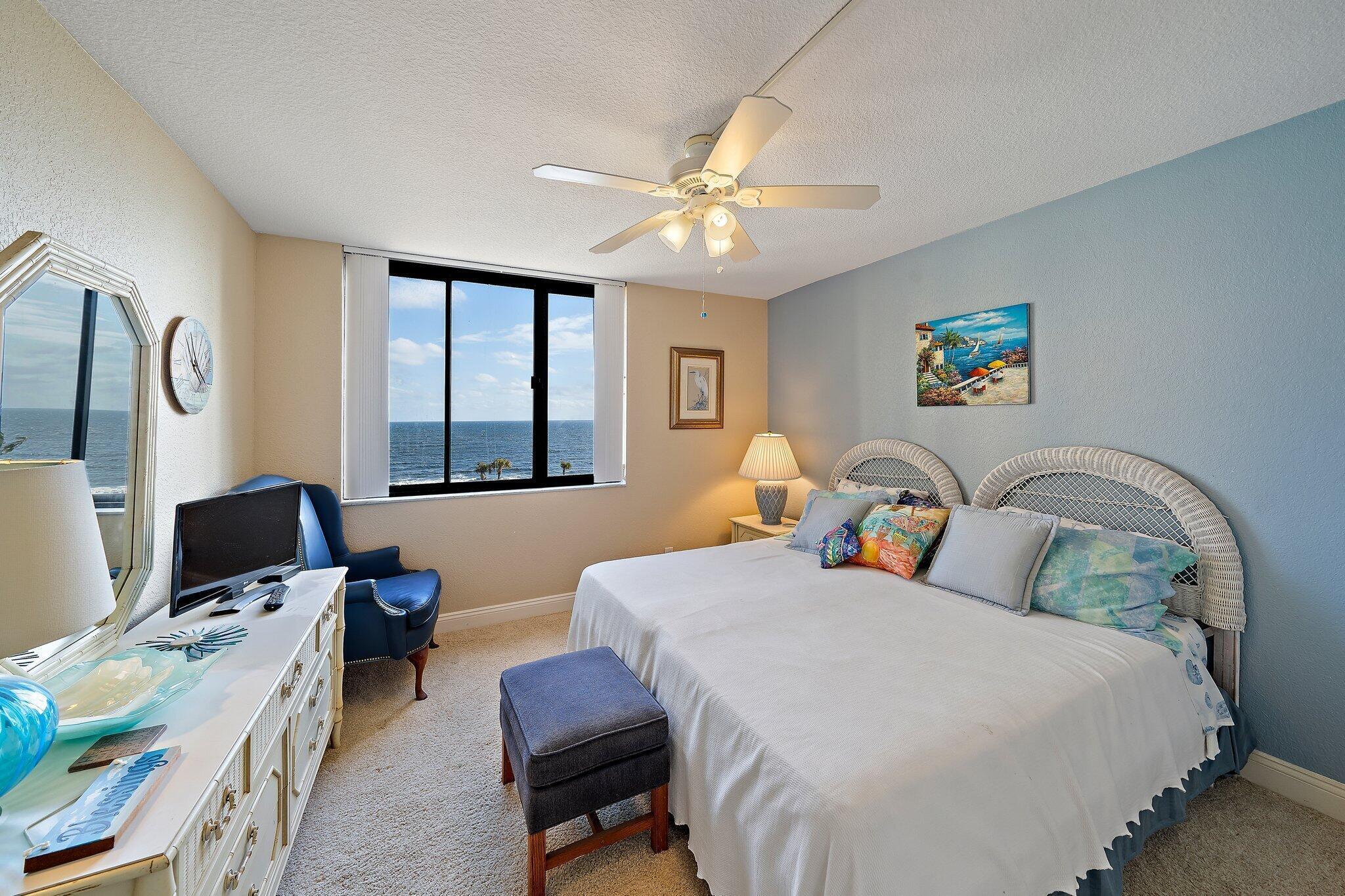 100 Ocean Trail Way, Unit 609 Jupiter, FL 33477 - Photo 24 of 66 a bedroom with bed a computer on desk and a dresser next to a window