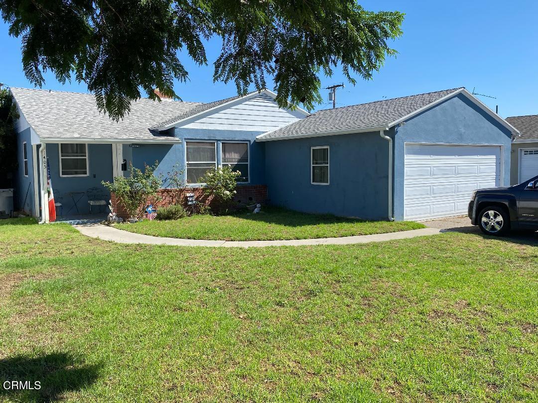 1405 Palm Drive Oxnard, CA 93030 - Photo 1 of 2 a front view of a house with a yard and garage