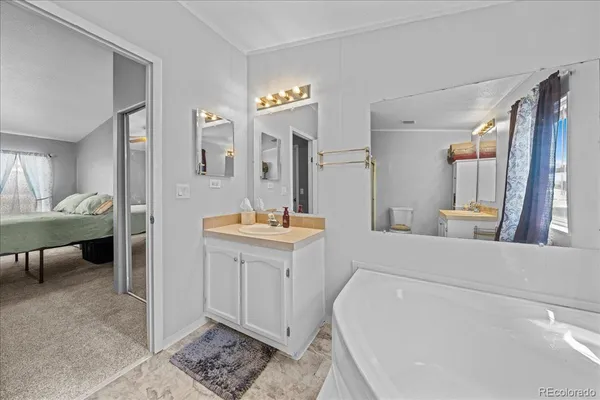 a en suite bathroom with a sink and a mirror