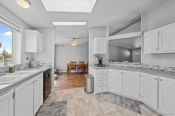 a kitchen with granite countertop a sink and cabinets