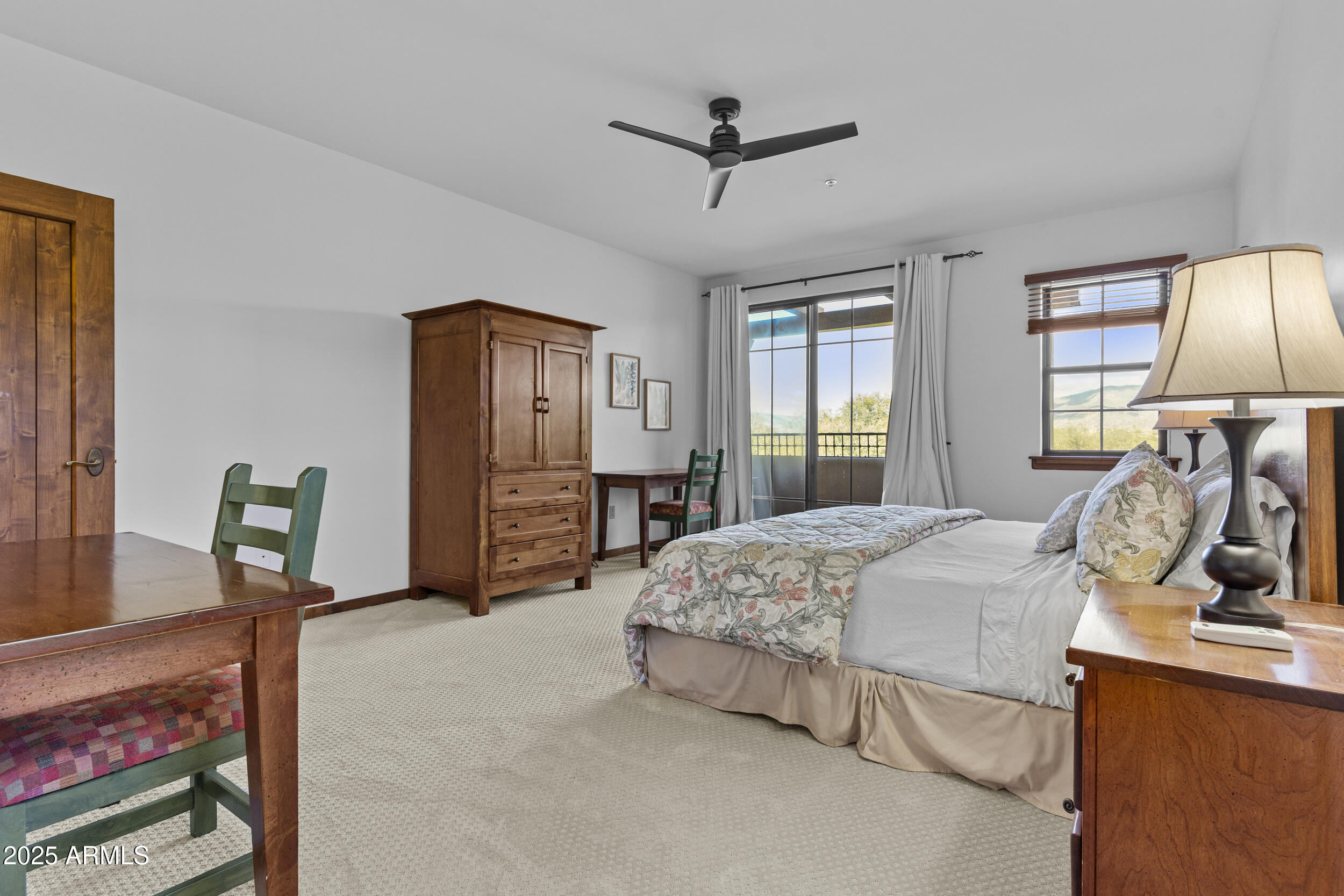 36601 North Mule Train Road, Unit D18 Carefree, AZ 85377 - Photo 24 of 53 a spacious bedroom with a bed a dresser and a chandelier
