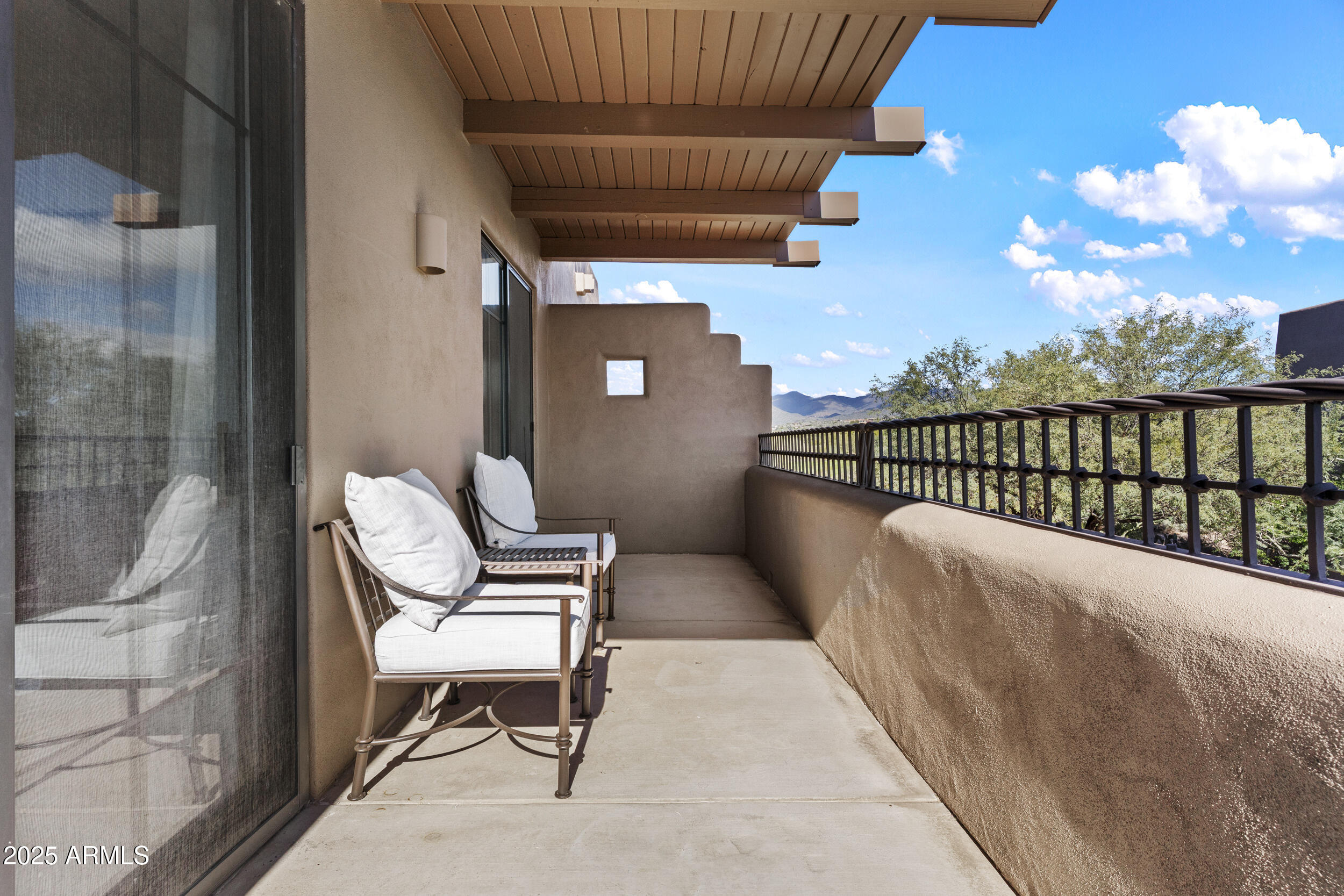 36601 North Mule Train Road, Unit D18 Carefree, AZ 85377 - Photo 31 of 53 a balcony with chairs and a potted plant