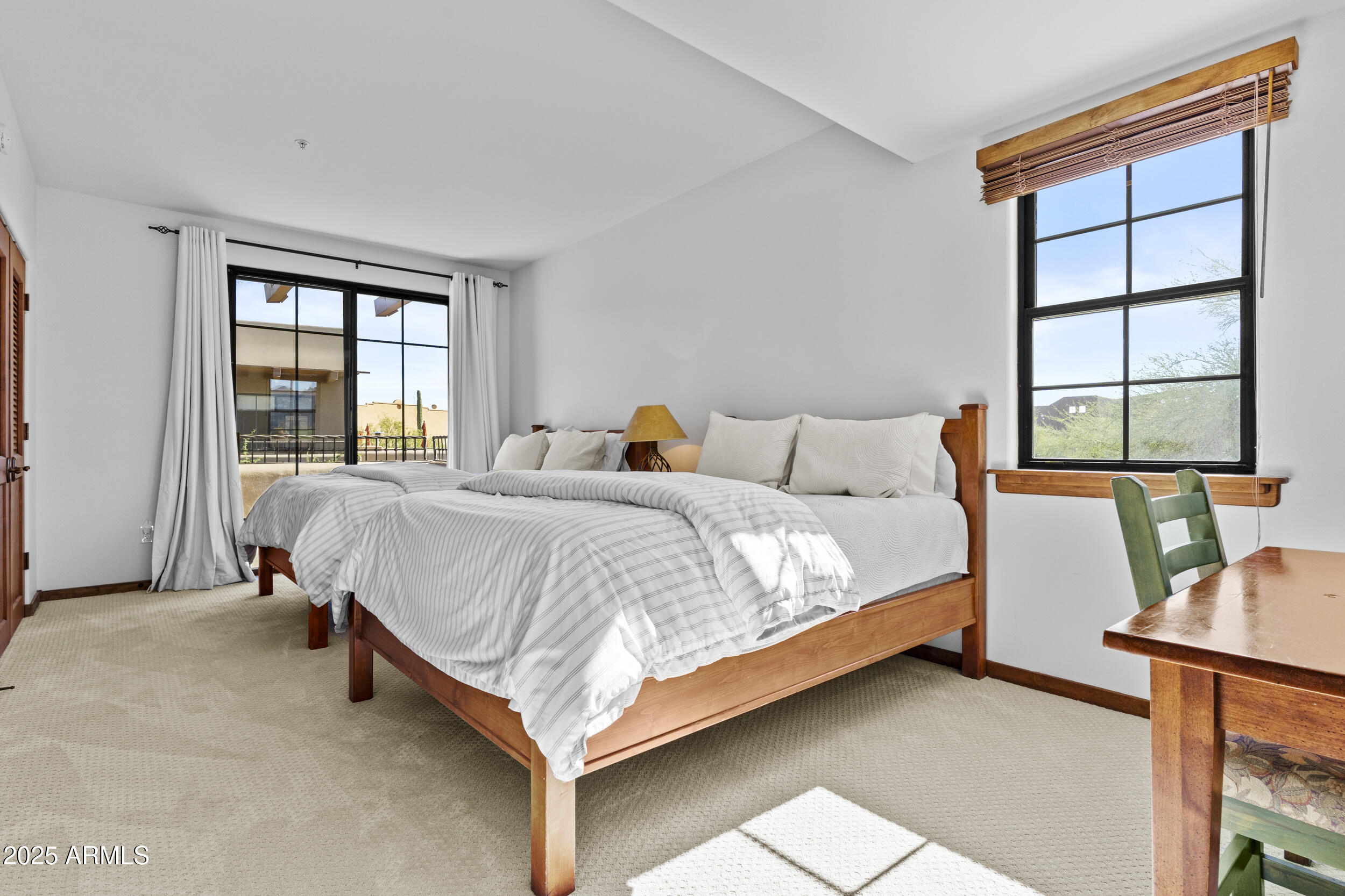 36601 North Mule Train Road, Unit D18 Carefree, AZ 85377 - Photo 33 of 53 a bedroom with a bed and large windows