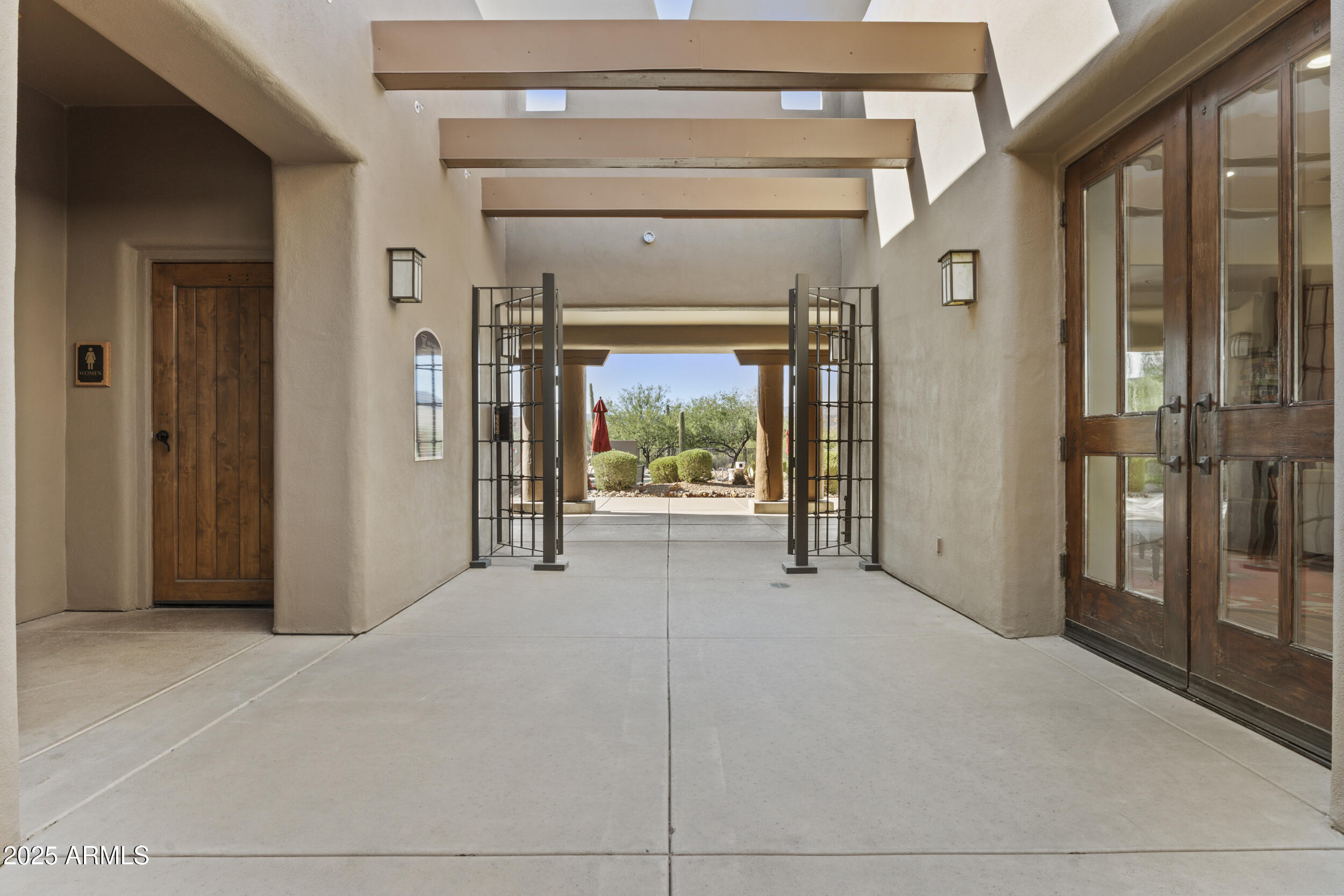 36601 North Mule Train Road, Unit D18 Carefree, AZ 85377 - Photo 44 of 53 a view of a hallway with wooden floor and a fireplace