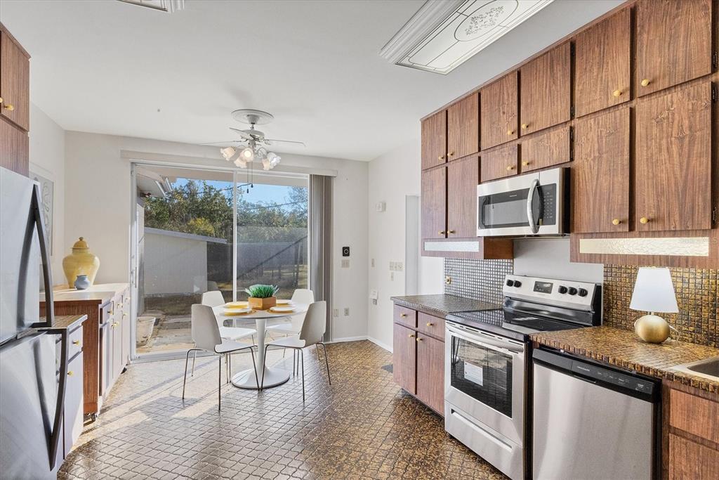 2605 Desoto Road Sarasota, FL 34234 - Photo 20 of 57 a kitchen with stainless steel appliances granite countertop a stove a sink and a refrigerator