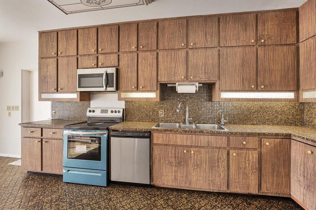 2605 Desoto Road Sarasota, FL 34234 - Photo 26 of 57 a kitchen with stainless steel appliances granite countertop a stove a sink and a microwave