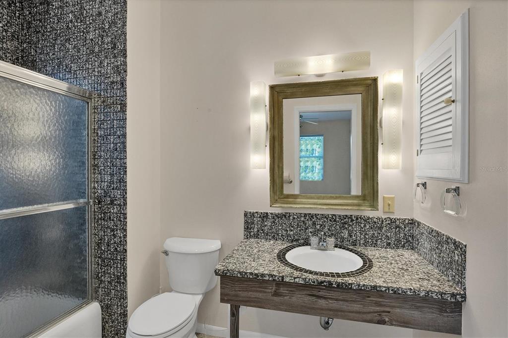 2605 Desoto Road Sarasota, FL 34234 - Photo 29 of 57 a bathroom with a granite countertop sink toilet and mirror