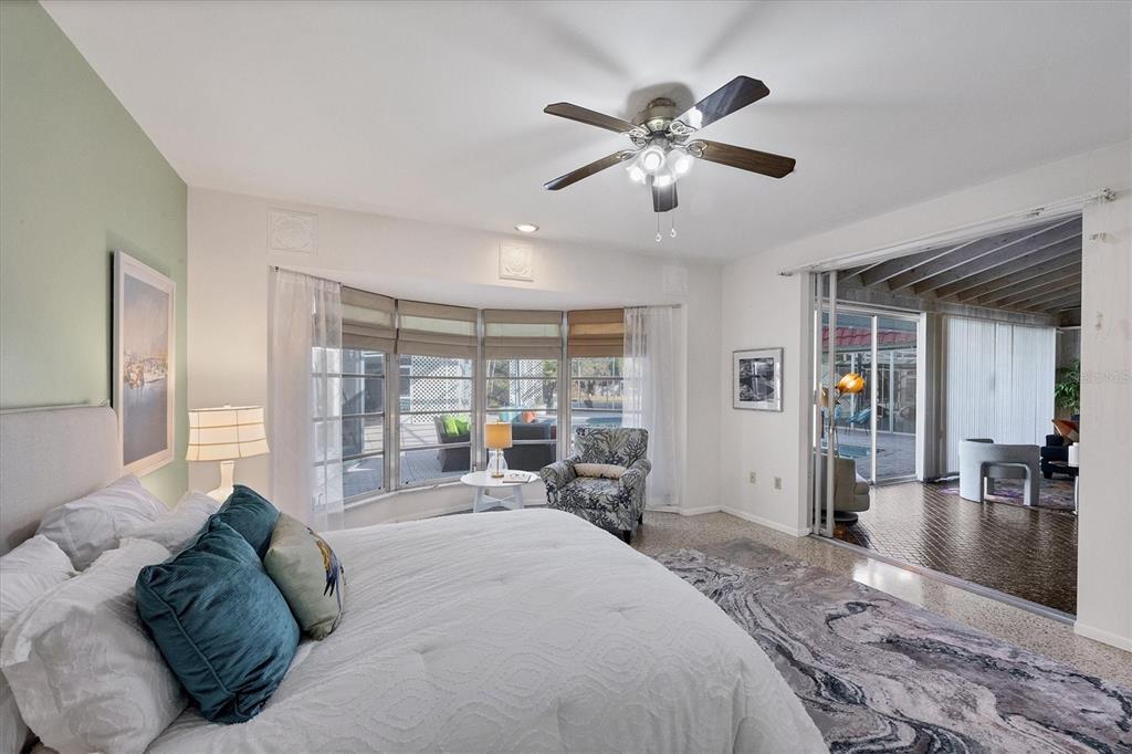 2605 Desoto Road Sarasota, FL 34234 - Photo 31 of 57 a spacious bedroom with a large bed and a chandelier