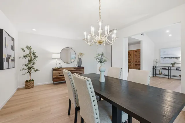 a view of a dining room with furniture wooden floor and chandelier
