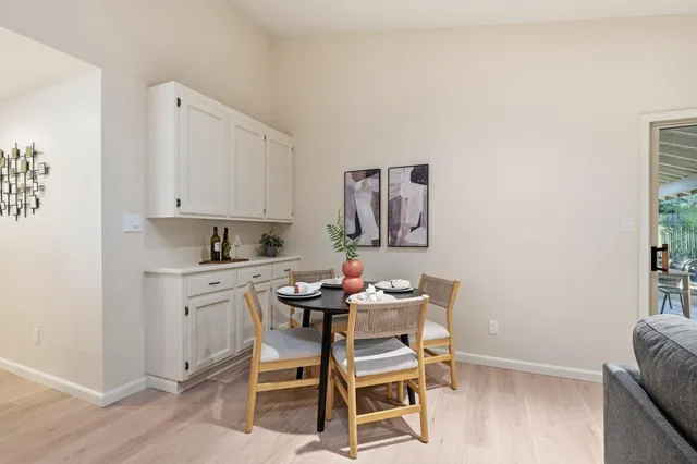 a dining room with furniture and wooden floor