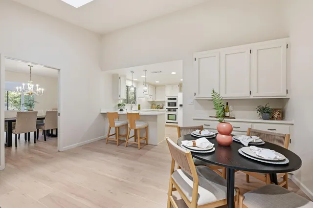 a view of a dining room with furniture and chandelier