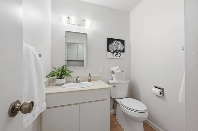 a bathroom with a toilet sink and mirror