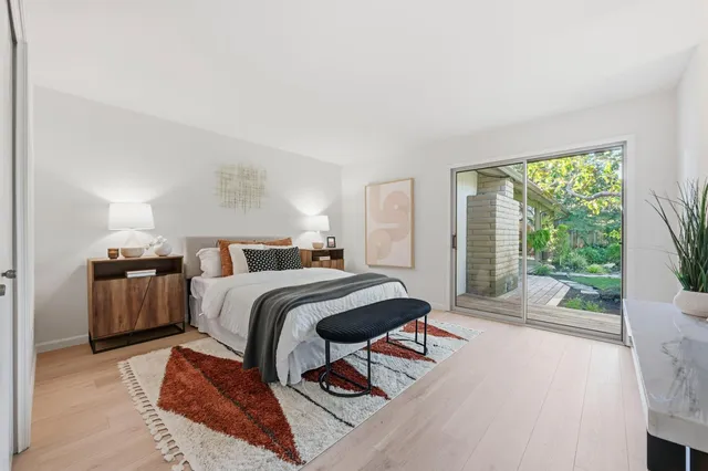 a bedroom with a bed and glass door
