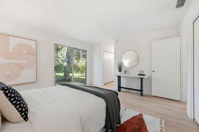 a bedroom with a bed lamps and window