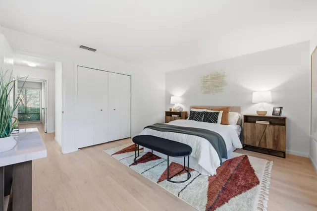 a bedroom with a bed and a table in it