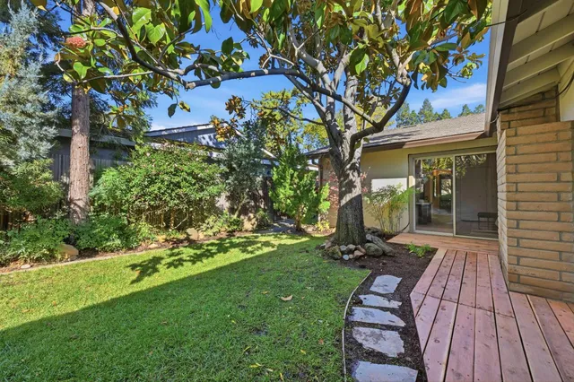 a view of a backyard with sitting area