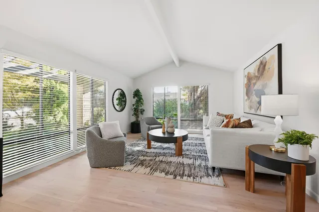a living room with furniture and a floor to ceiling window