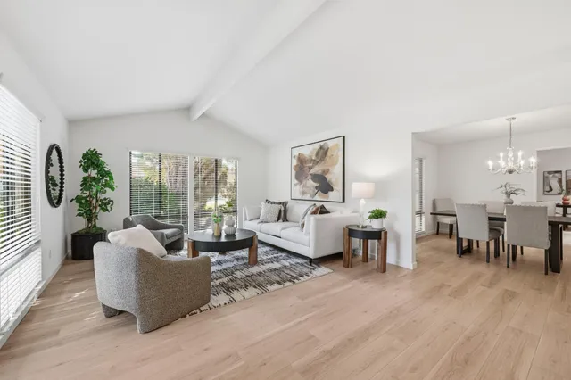 a living room with furniture dining area and a large window