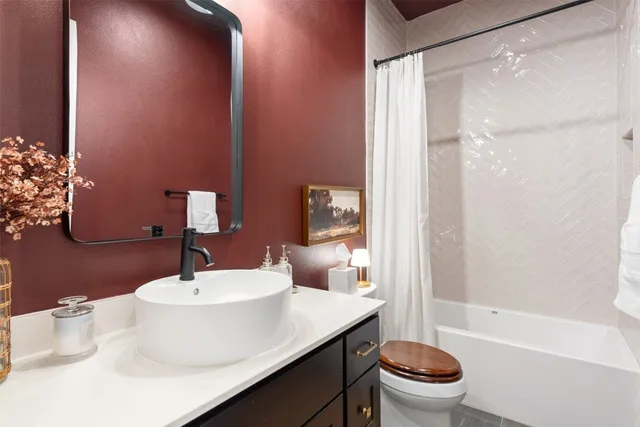 a bathroom with a sink toilet and shower