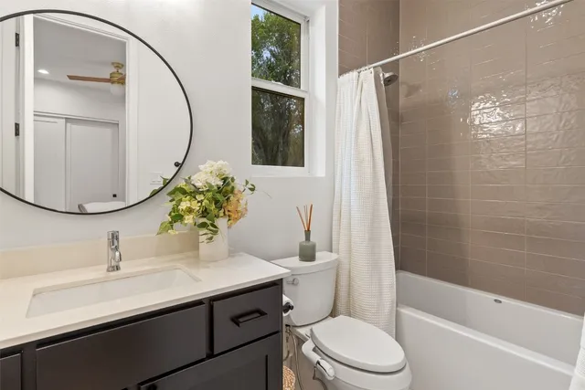 a bathroom with a sink a toilet and a mirror