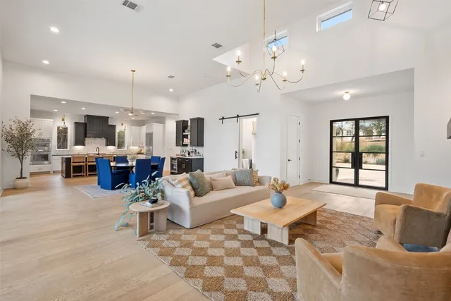 a living room with furniture and a chandelier