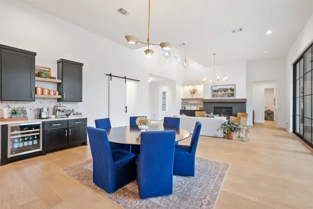 a view of kitchen with refrigerator stove dining table and chairs