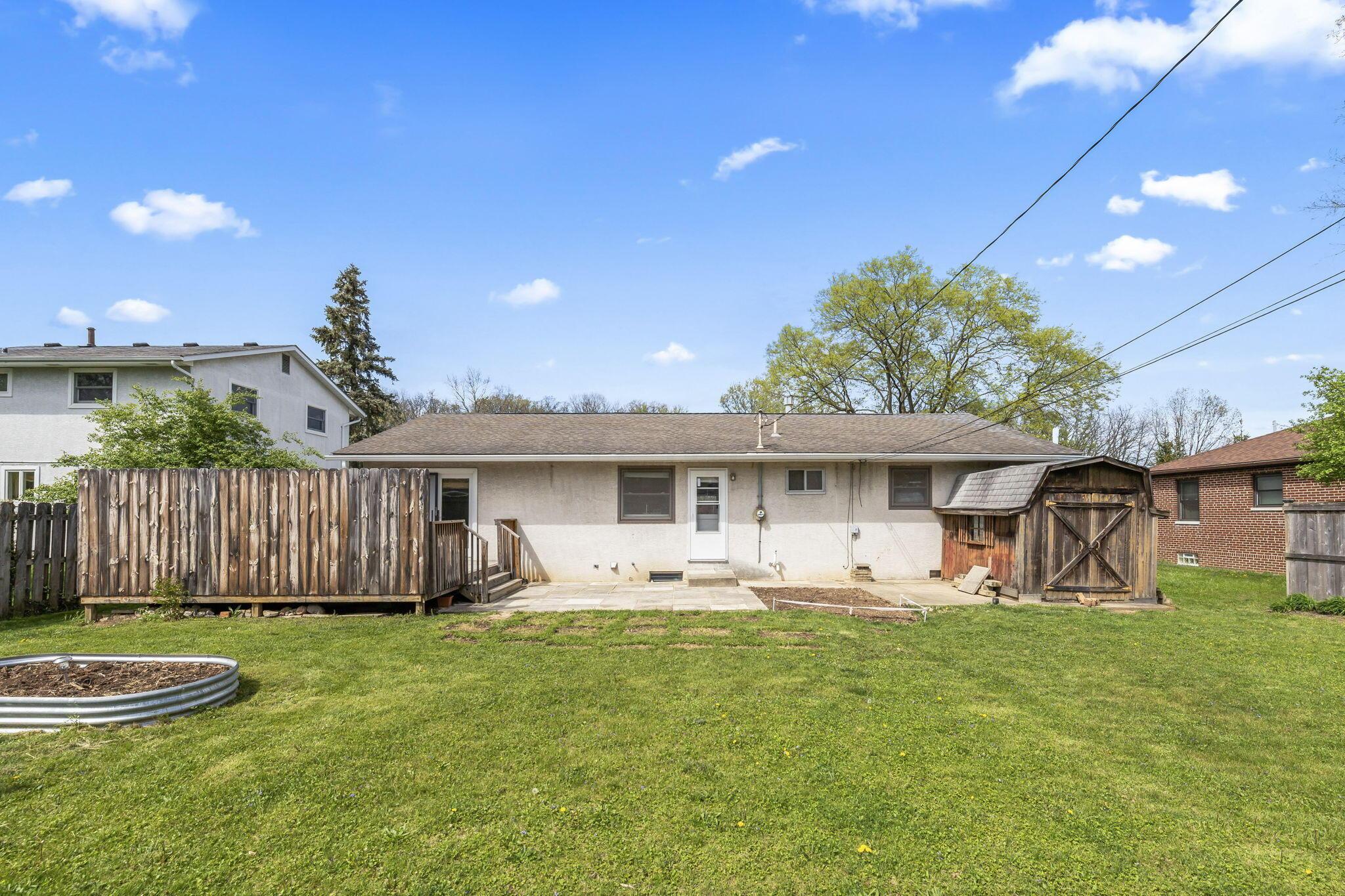 1247 Fishinger Road Columbus, OH 43221 - Photo 3 of 27 Back of yard with patio, deck, shed and garden beds