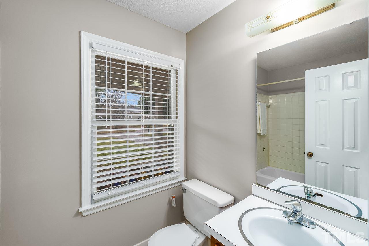 709 Merwin Road Raleigh, NC 27606 - Photo 22 of 30 a bathroom with a sink toilet and shower