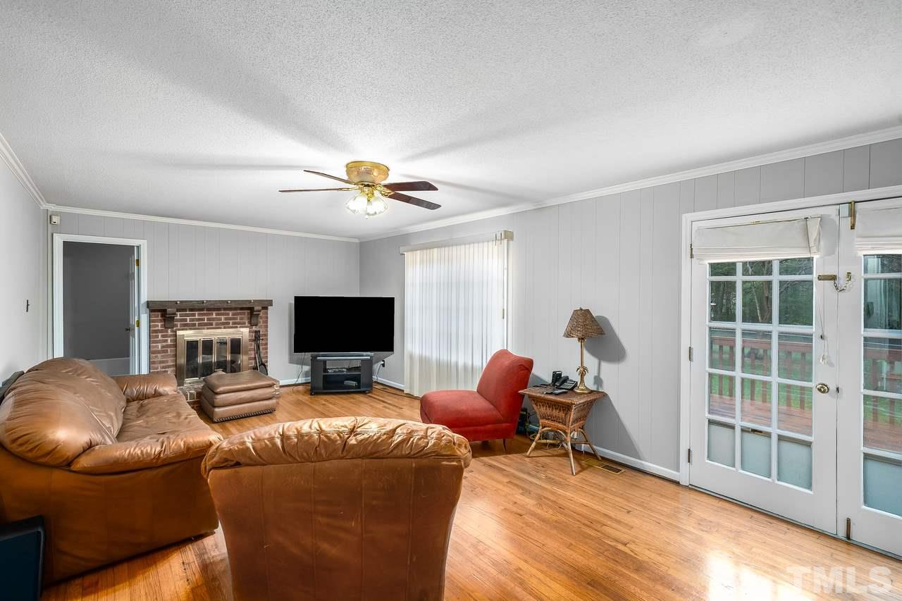 709 Merwin Road Raleigh, NC 27606 - Photo 5 of 30 a living room with furniture and a flat screen tv