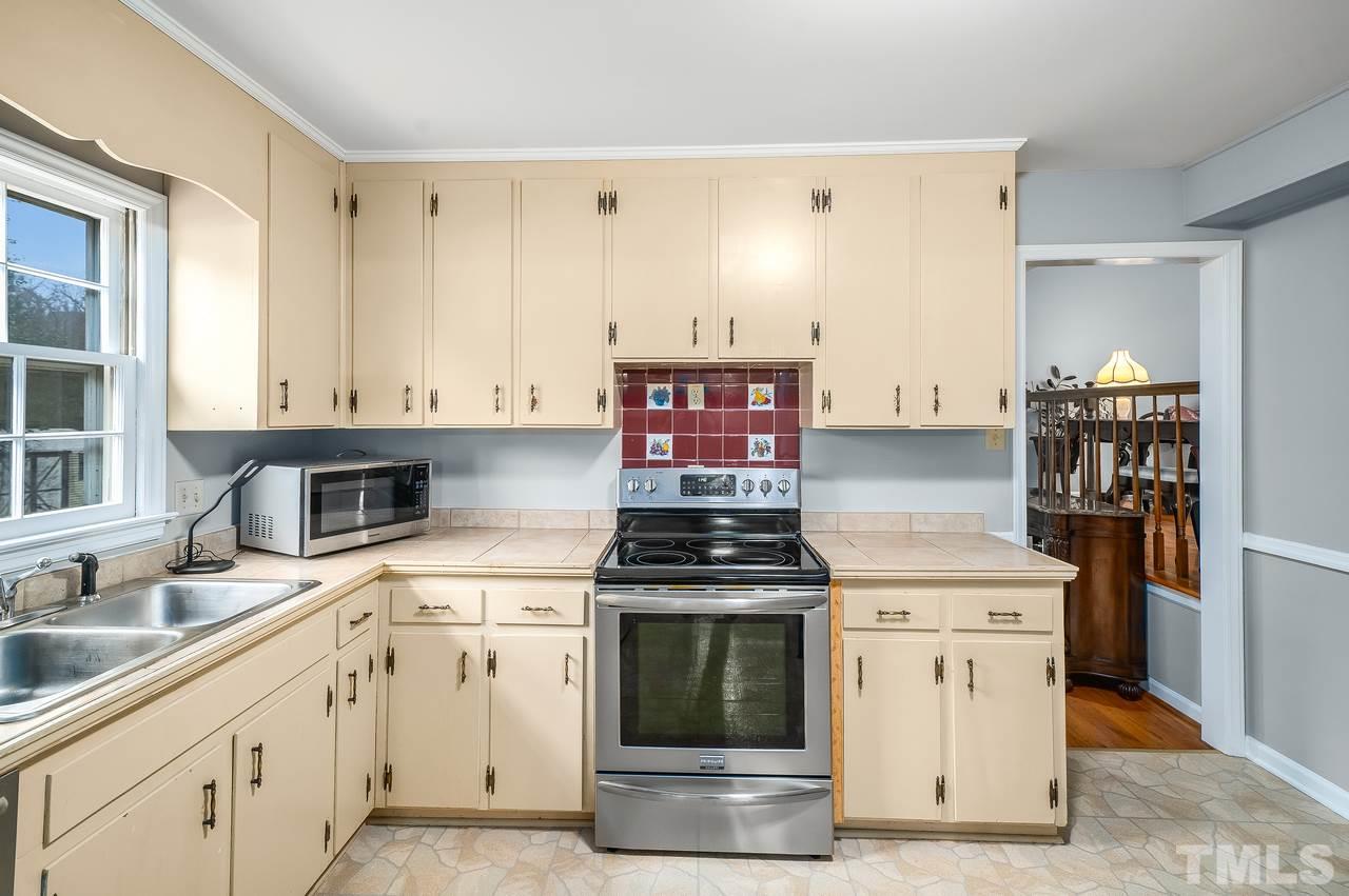 709 Merwin Road Raleigh, NC 27606 - Photo 8 of 30 a kitchen with a stove and a sink