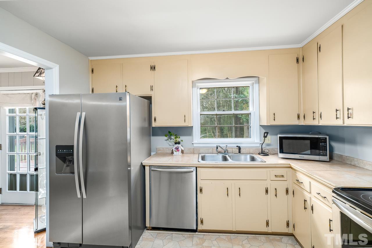 709 Merwin Road Raleigh, NC 27606 - Photo 9 of 30 a kitchen with a refrigerator sink and cabinets