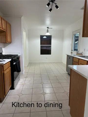 a kitchen with granite countertop cabinets stainless steel appliances and a window
