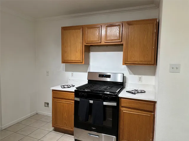 a kitchen with a sink a stove cabinets and utility room