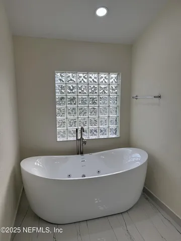 a white bath tub sitting in a bathroom