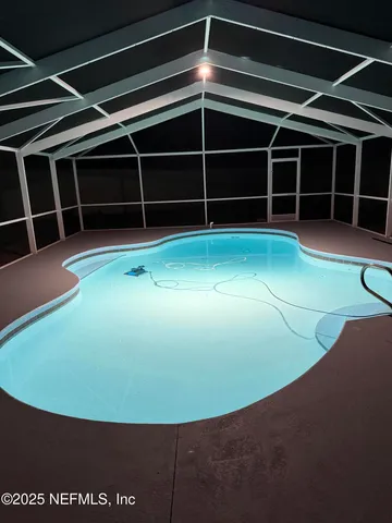 a view of an empty room with a cabinet and a window