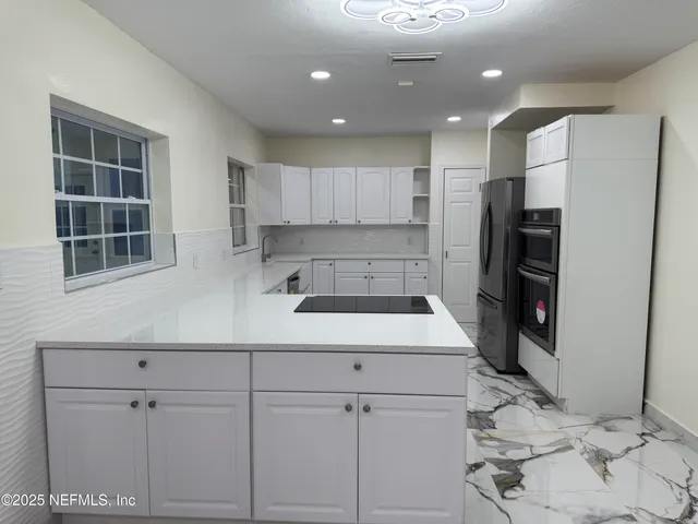 a kitchen with a sink stainless steel appliances and cabinets