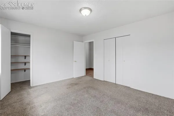 a view of an empty room and a window