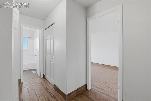 a view of a hallway with wooden floor