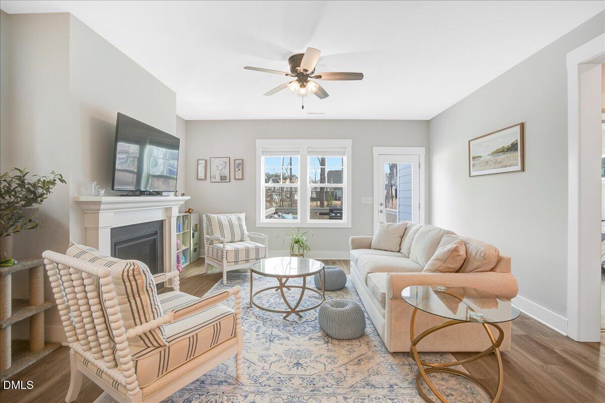 1105 Logperch Way Wendell, NC 27591 - Photo 6 of 29 a living room with furniture a fireplace and a large mirror