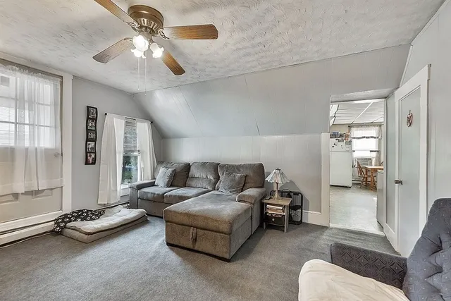 a living room with furniture gym equipment and a chandelier