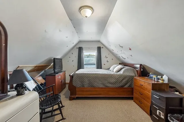 a spacious bedroom with a bed and a window