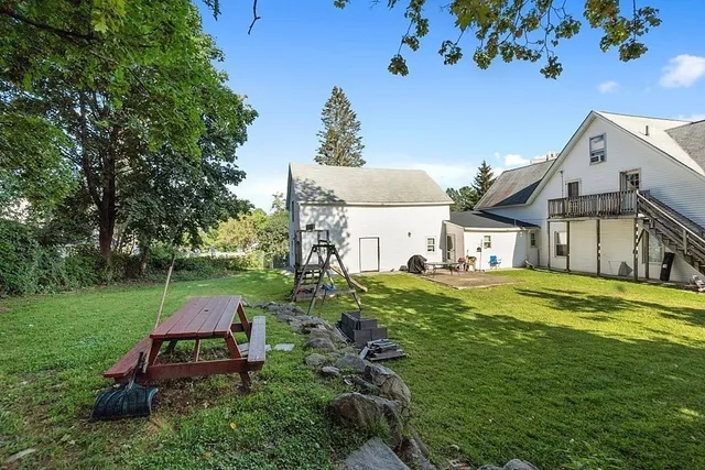 a aerial view of a house with swimming pool garden and patio