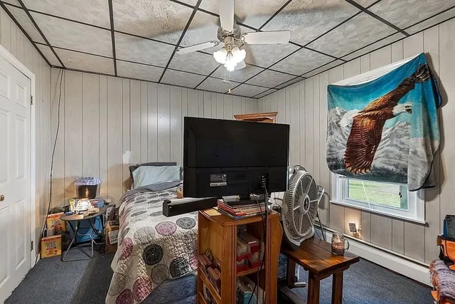 a bedroom with furniture and a flat screen tv