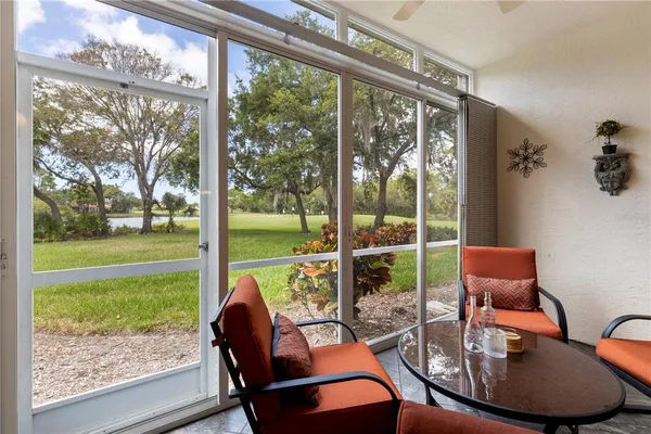 a outdoor living space with patio furniture and a glass door