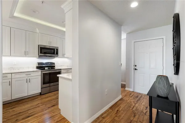 a kitchen with a sink a microwave a stove and refrigerator