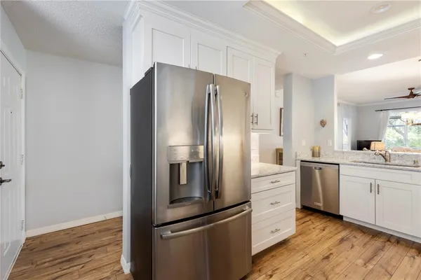 a kitchen with cabinets appliances a sink and a counter top space